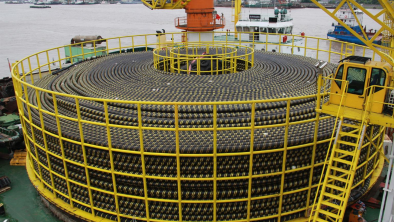 Large subsea cable wound onto a circular carousel aboard an installation vessel